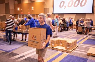 A student carries a box of food during UK's FUSION day of service